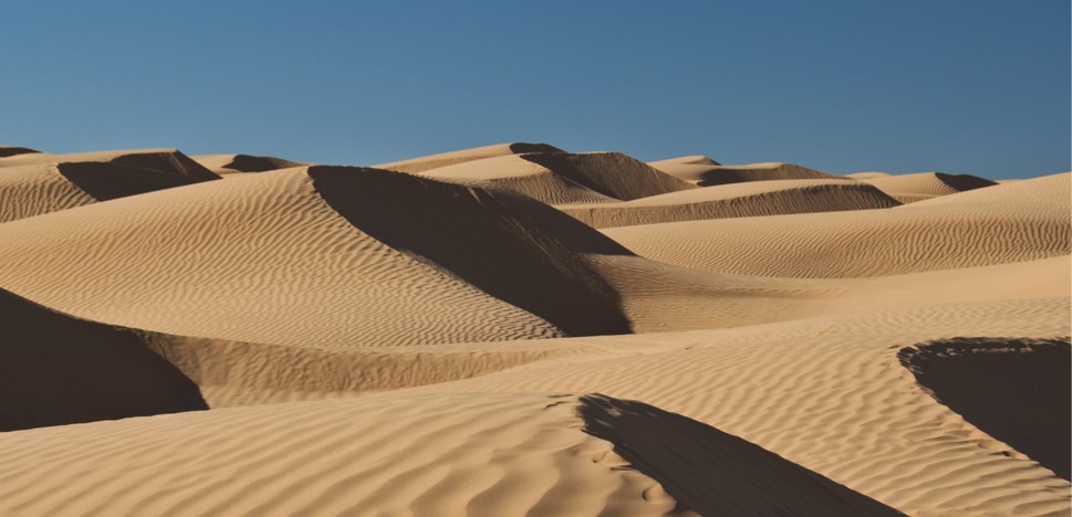 Pohled na písečné duny v poušti.